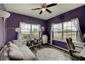 Stylish office with large windows, hardwood floors, purple walls, and bright natural light at 951 Gondola Run, Greenfield, IN 46140