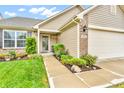 Beautiful home featuring a welcoming entrance with well-maintained landscaping and an attached two-car garage at 10731 Jimmy Lake Dr, Indianapolis, IN 46239