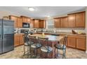 Well-equipped kitchen with stainless steel appliances, an island with bar stools, and lots of storage at 10731 Jimmy Lake Dr, Indianapolis, IN 46239