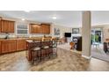 Spacious open-concept kitchen featuring an island with bar seating and seamless flow into the living area at 10731 Jimmy Lake Dr, Indianapolis, IN 46239