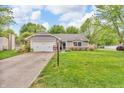 Well-maintained home with a welcoming front yard, attached garage, and a charming 'Welcome' sign at 1104 Briarwood Dr, Brownsburg, IN 46112