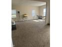 Large carpeted living room featuring bright windows and ample natural light, perfect for relaxation at 1128 S Pennsylvania St, Indianapolis, IN 46225