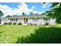 Charming single-story home with well-maintained lawn, trimmed bushes, and pleasant curb appeal at 12144 Trolley Rd, Indianapolis, IN 46236