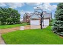 Beautiful brick home with a spacious driveway, three-car garage, and well-maintained landscaping at 13145 Roma Bnd, Carmel, IN 46074