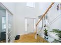 Bright foyer with hardwood floors, a staircase, and decorative details at 14135 Nicholas Dr, Carmel, IN 46074