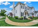 White brick home featuring black shutters, landscaping and a sidewalk running in front of the house at 15116 Fenchurch Dr, Westfield, IN 46074
