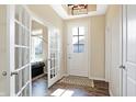 Inviting foyer with hardwood floors and natural light from glass paneled door at 15116 Fenchurch Dr, Westfield, IN 46074