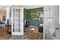 Bright office space featuring french doors, hardwood floors, and decorated green walls at 15116 Fenchurch Dr, Westfield, IN 46074