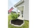 Quaint front porch with charming rocking chairs and lush landscaping, creating a welcoming entryway at 1880 Explorer Ct, Franklin, IN 46131