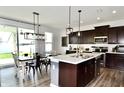Modern kitchen featuring a large island, stainless steel appliances, and an adjacent dining area at 1880 Explorer Ct, Franklin, IN 46131