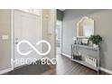 Inviting entryway with a console table, decorative mirror, and stylish gray walls at 19175 English Lake Ln, Noblesville, IN 46062