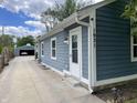 Home exterior featuring blue siding, white trim, a detached garage, and a well maintained lawn at 1931 E 68Th St, Indianapolis, IN 46220