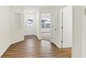 Bright entryway featuring wood-look floors, white walls, and a door with glass inserts at 19584 Atwater Ave, Sheridan, IN 46069