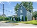 Quaint two-story home with mature trees, well-maintained landscaping and inviting curb appeal at 2215 S Delaware St, Indianapolis, IN 46225