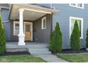 Charming front porch with painted pillars, manicured landscaping, and updated front door at 2215 S Delaware St, Indianapolis, IN 46225
