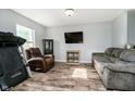 Comfortable living room featuring a plush sofa and a wall-mounted TV at 2258 Bridlewood Dr, Franklin, IN 46131