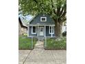 Charming single-story home with a fenced yard and a mature tree at 23 S Holmes Ave, Indianapolis, IN 46222