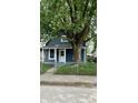 Charming single-story home with a fenced yard and a mature tree at 23 S Holmes Ave, Indianapolis, IN 46222