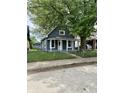 Charming single-story home with a fenced yard and a mature tree at 23 S Holmes Ave, Indianapolis, IN 46222