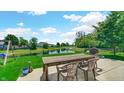 Inviting backyard featuring a patio with seating and scenic pond views and fence at 237 Broadmoor Bnd, Pittsboro, IN 46167