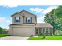 Two-story home with vinyl siding, brick accents, and attached two-car garage on a sunny day at 237 Broadmoor Bnd, Pittsboro, IN 46167