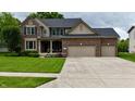 Charming two-story brick and vinyl home with a well-manicured lawn and a spacious three-car garage at 3251 Amber Way, Bargersville, IN 46106