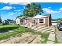 Charming single story home with an inviting wooden access ramp and a well-manicured lawn at 3310 Ransdell St, Indianapolis, IN 46227