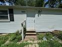 Front entrance of home with white door, brick pathway, and lush garden at 3403 Coffey St, Indianapolis, IN 46217
