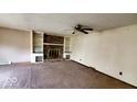 Open living room with brick fireplace, built-in bookshelves, and neutral paint at 3702 Candy Cane Dr, Indianapolis, IN 46227