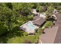 Aerial view of community pool with lounge chairs, surrounded by lush landscaping and trees at 3852 Knollton Rd # 3852, Indianapolis, IN 46228