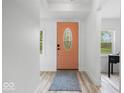 Bright foyer featuring a stylish front door with a glass insert, light walls, and modern flooring at 450 Pleasant St, Noblesville, IN 46060