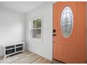 Inviting foyer with a decorative front door, a convenient storage bench, and wood-look flooring at 450 Pleasant St, Noblesville, IN 46060