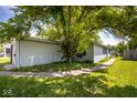 Exterior shot with light gray vinyl siding and sidewalk at 4625 N Sadlier Dr, Indianapolis, IN 46226