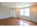 Living room featuring wood-look floors, windows and white door at 4625 N Sadlier Dr, Indianapolis, IN 46226