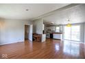 Open-concept living area with wood-look floors flowing into kitchen at 4625 N Sadlier Dr, Indianapolis, IN 46226