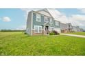 Two-story home with light blue siding and a well-maintained lawn at 4712 Clairmont Dr, Columbus, IN 47203