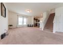 Bright living room with plush carpeting and an open floor plan at 4712 Clairmont Dr, Columbus, IN 47203