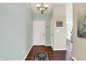 Inviting foyer with hardwood floors, white door, and neutral walls at 4824 Eagles Watch Ln, Indianapolis, IN 46254
