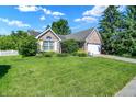 Well maintained lawn and landscaping highlight this beautiful single-story home and attached garage at 4824 Eagles Watch Ln, Indianapolis, IN 46254