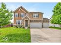 Charming two-story home with well-maintained lawn and a two-car attached garage on a sunny day at 532 Amersham Ct, Avon, IN 46123