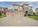 Inviting two-story home featuring brick and vinyl accents, a spacious driveway, and a neatly maintained lawn at 548 Gosford Ct, Westfield, IN 46074