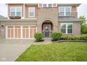 Beautiful two-story home with brick and vinyl siding, attached garage, and well-manicured landscaping at 548 Gosford Ct, Westfield, IN 46074