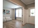 Bright foyer boasts wood floors and a white front door adjacent to a cozy living area at 548 Gosford Ct, Westfield, IN 46074