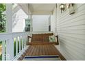 Covered porch featuring wood floors, a hanging swing and a rug, creating a cozy outdoor space at 5480 E County Rd 800 N, Brownsburg, IN 46112