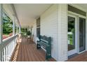Covered porch featuring wood floors and a bench, creating a cozy outdoor space at 5480 E County Rd 800 N, Brownsburg, IN 46112