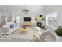 Bright living room with vaulted ceilings, fireplace, large windows, and modern decor, creating a welcoming atmosphere at 5503 Wilder Way, Indianapolis, IN 46216