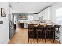 Modern kitchen featuring stainless steel appliances, white cabinets, and a breakfast bar at 609 E 39Th St, Indianapolis, IN 46205