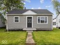 Single-story home featuring a well-manicured lawn and inviting entrance at 618 Miller Ave, Shelbyville, IN 46176