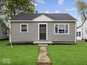 Well-maintained single-story home with a tidy front lawn and classic facade at 618 Miller Ave, Shelbyville, IN 46176