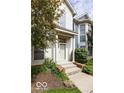 Welcoming two-story home with a cozy front entrance, beautiful landscaping, and natural light at 654 N Senate Ave, Indianapolis, IN 46202